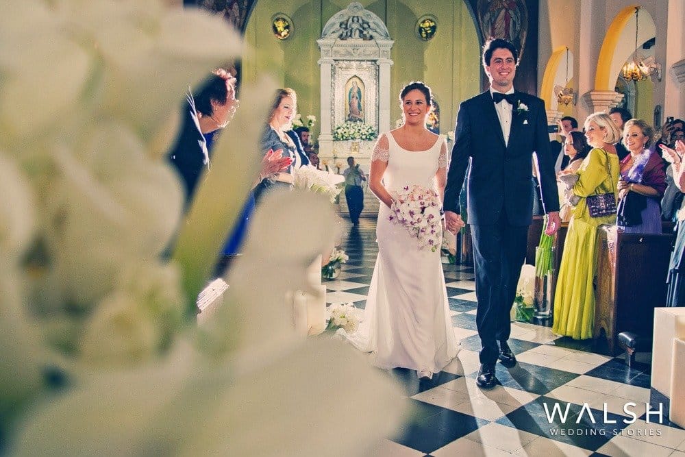 novios saliendo de iglesia Ceiba de Guadalupe. Fotógrafos de boda en San Salvador