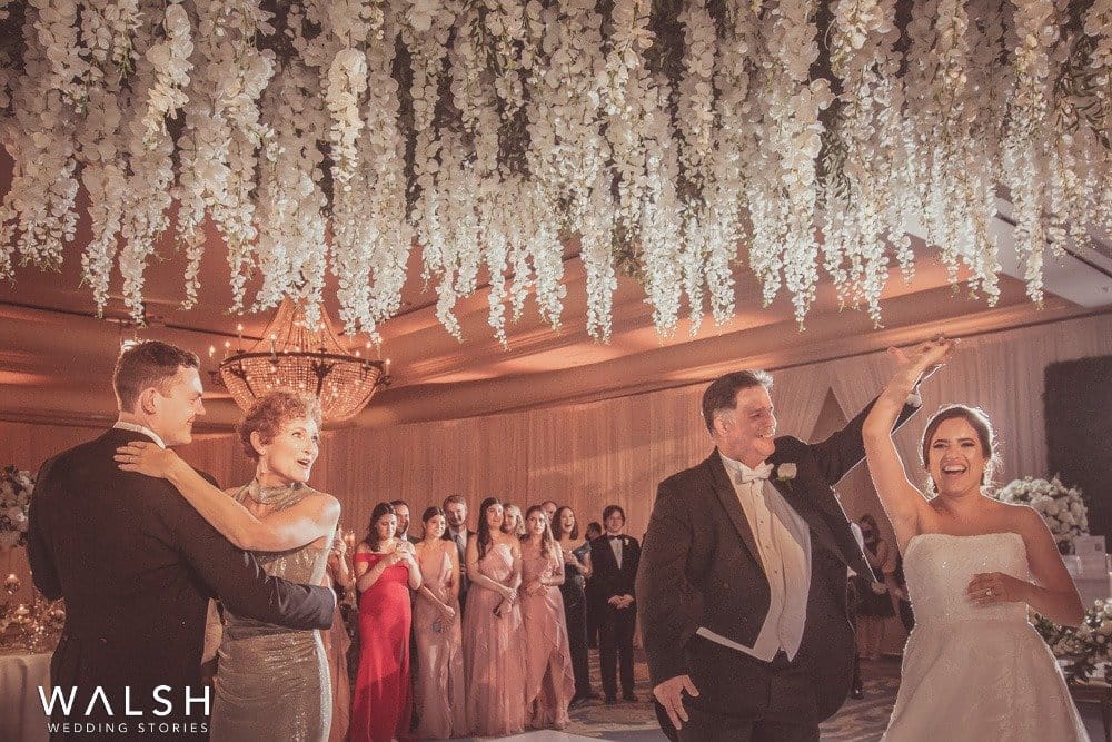 bride and groom dancing with parents at wedding